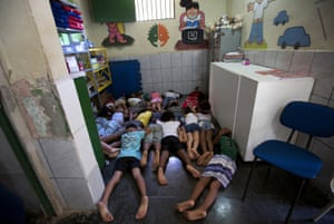 Students practice taking cover in a classroom at a school in the Mare slum. With rival drug dealers on practically every corner and a militarised campaign to tackle them, shootouts have become so common that the school holds safety drills for students.