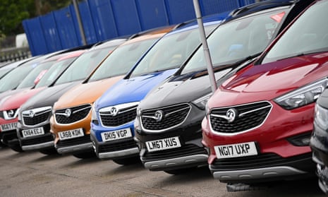 Car are parked on the forecourt of a Vauxhall dealership