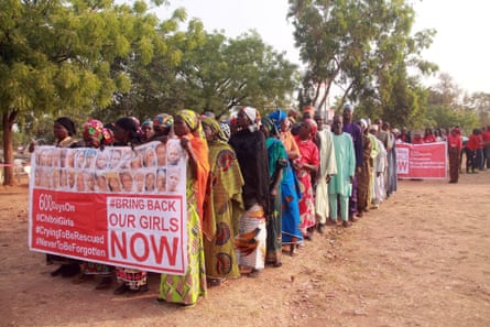 Members of the ‘Bring Back Our Girls’ movement and mothers of the missing schoolgirls, holding a banner showing photographs of some of the missing in 2016.