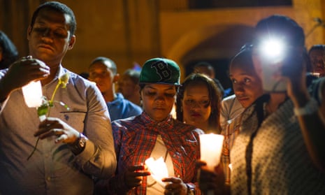 In Santo Domingo, people light candles and listen to speakers at a memorial gathering for those killed in Orlando