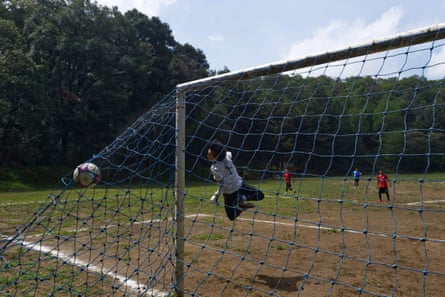A player scores a goal in a football match on top of the Teoca volcano. 