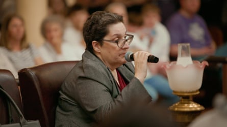 A middle-aged women speaking into a microphone