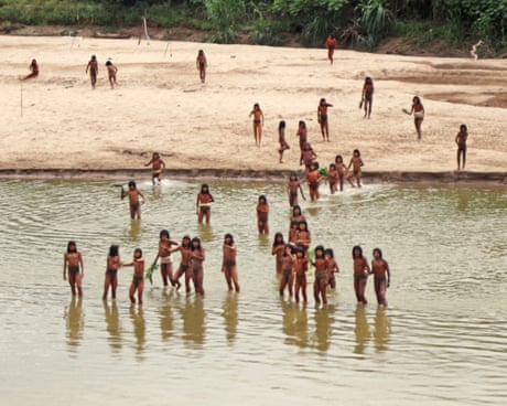 Members of the Mashco Piro Indigenous community, a reclusive tribe, gather on the banks of the Las Piedras River