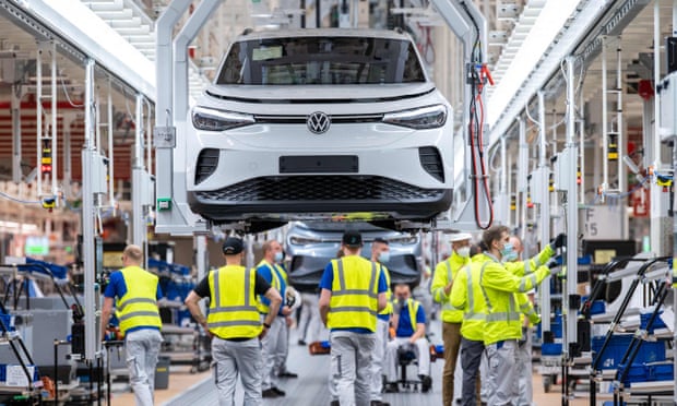 Employees work at the assembly line for the Volkswagen ID 4 electric car of German carmaker Volkswagen