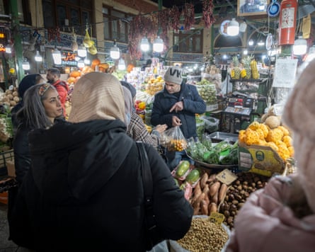 Iranian women shop for fruits and vegetables in northern Tehran