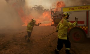 Firefighters battle a bushfire near Braidwood, New South Wales, on Friday.
