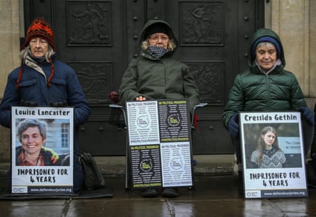 Protesters hold portraits of Louise Lancaster and Cressida Gethin during a vigil in Cambridge in December 2024.