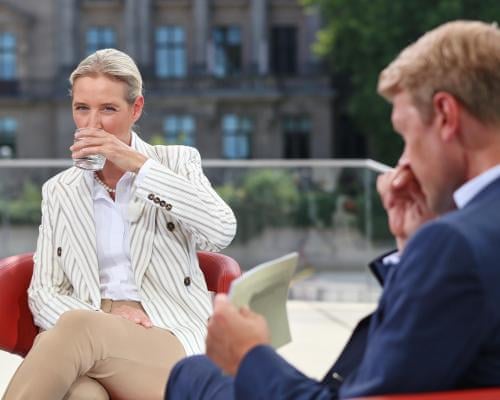 Protesters play Scheiß AfD song during interview with far-right co-leader Alice Weidel – video | Alternative für Deutschland (AfD) | The Guardian