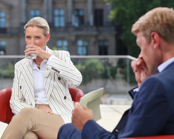 Protesters play 'scheiß AfD' song during interview with far-right co-leader Alice Weidel – video