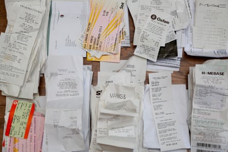 A sorted pile of various coloured receipts