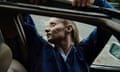 Charlotte Day Wilson leaning backwards out of a car window