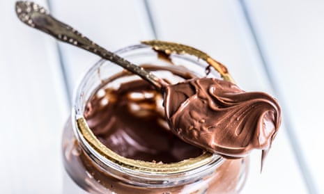 Chocolate spread in spoon. A jar of hazelnut chocolate spread.Chocolate spread in spoon. A jar of hazelnut chocolate spread.
