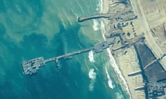 FILE - The image provided by U.S, Central Command, shows U.S. Army soldiers assigned to the 7th Transportation Brigade (Expeditionary), U.S. Navy sailors assigned to Amphibious Construction Battalion 1, and Israel Defense Forces placing the Trident Pier on the coast of Gaza Strip on May 16, 2024. A key section of the U.S. military-built pier designed to carry badly needed aid into Gaza by boat has been reconnected to the Gaza beach following storm damage repairs and aid will begin to flow soon, the U.S. Central Command announced Friday. (U.S. Central Command via AP)
