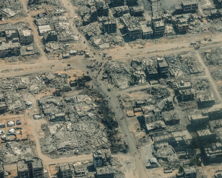 People can be seen gathering around the rubble of a suburb in central Gaza Strip, in a photo taken from a Jordanian plane.