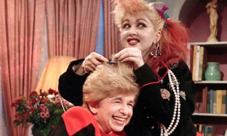 Sex therapist Dr. Ruth Westheimer cracks up as rock singer Cyndi Lauper does her hair up in “punk” style, in New York, Jan. 17, 1985