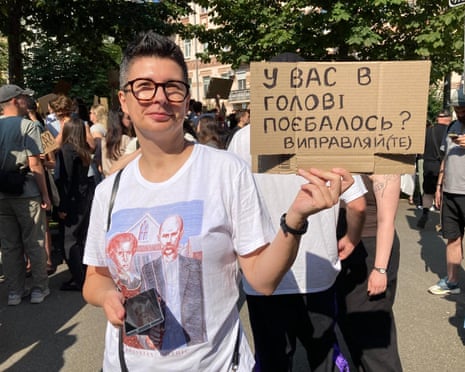 Julia Gagarina taking part in a protest against Volodymyr Zelenskyy’s decision to fire defence minister Mykhailo Fedorov, with a placard saying “Is your head screwed on right?”, in Kyiv, Ukraine