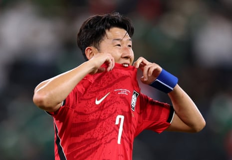Son Heung-min bites his shirt in frustration.