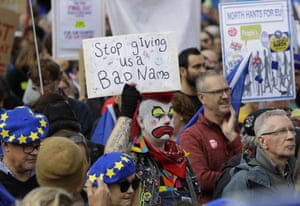 Anti-Brexit demonstrators carry placards and EU flags.