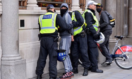 A man is stopped and searched by police in St James's Street, London, June 2020.