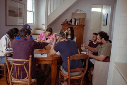 A group of friends at a table drinking and taste testing ginger beers.