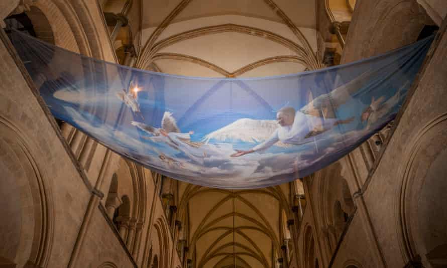 Angels are printed on see-through fabric suspended over the chancel arch.