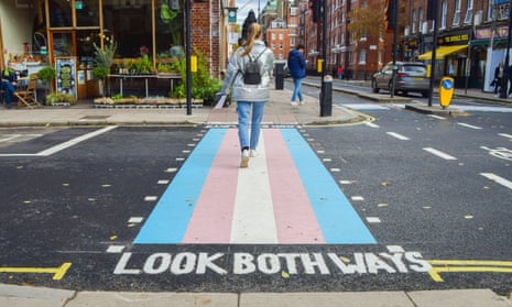 A pedestrian crossing with trans flag colours in central London.