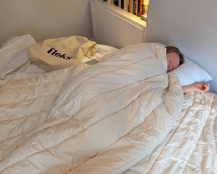 The writer lays in bed under a Floks duvet