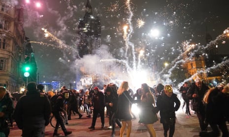 Fireworks are let off as people take part in the Million Mask March 2021 in Parliament Square, London