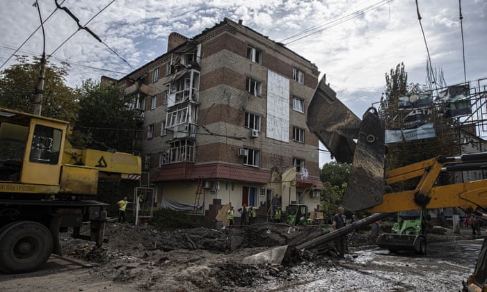 People clean up at the damaged sites after Russian missiles hit residential areas in Sloviansk city, Donetsk Oblast, Ukraine on August 15, 2022 (Photo by Metin Aktas/Anadolu Agency via Getty Images)