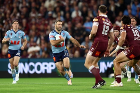 James Tedesco runs with the ball.