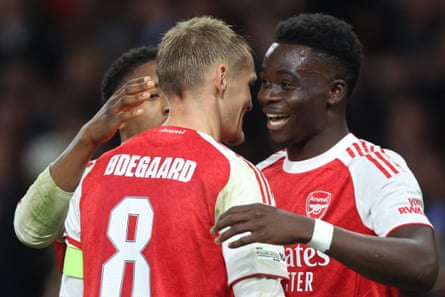 Bukayo Saka celebrates with Martin Ødegaard after scoring against Olympiakos