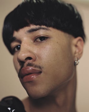 Portrait of young person holding ambiguous gaze.