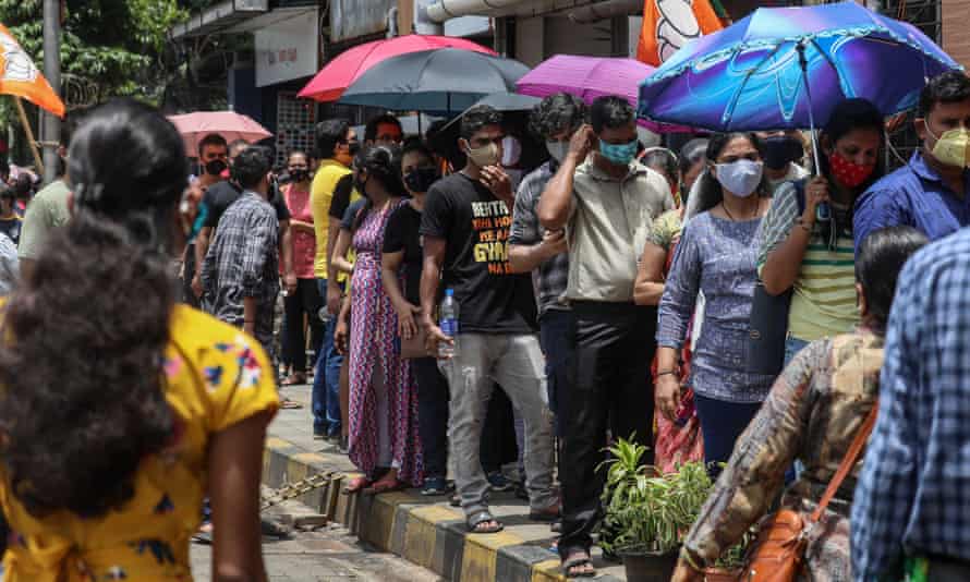 People wait to receive Covid-19 vaccine shots at a vaccination center in Mumbai, India.