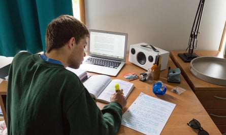 University student revising for exams in his room