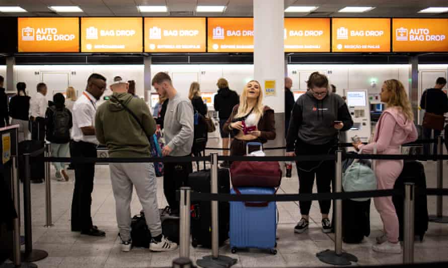 Travellers queue to check in for their EasyJet flights at Gatwick Airport in London, Britain, 31 May 2022.