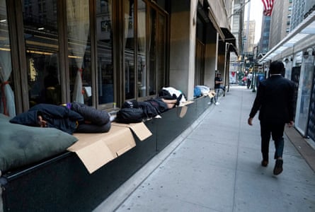 Migrants sleep outside the Roosevelt Hotel as they wait for placement in New York City on 1 August 2023.