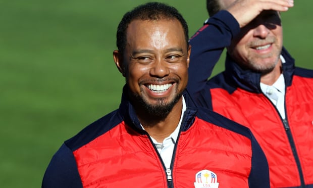 Tiger Woods finds a smile after not being allowed on the official United States team photo at Hazeltine