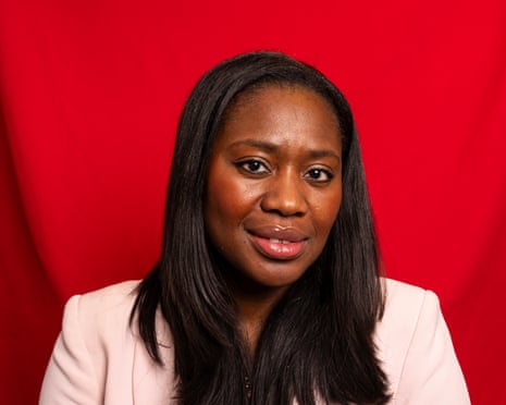Miatta Fahnbulleh sits against a red backdrop.