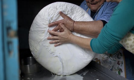Get it while you can: a halloumi takes shape in the expert hands of Cypriot women.