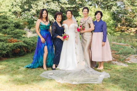 A bride and four women in her wedding party pose for a portrait outside