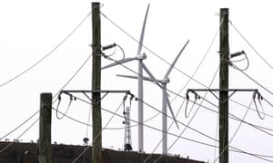 wind turbines seen behind electricity wires at Infigen Energy wind farm