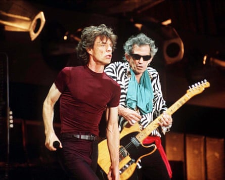 Keith Richards with a guitar and Mick Jagger holding a microphone