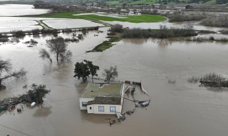 A home submerged in floodwater as the Salinas River begins to overflow its banks in Salinas, California.