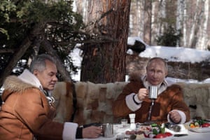 Shoigu and Putin sit down for a meal and drinks in the forest.