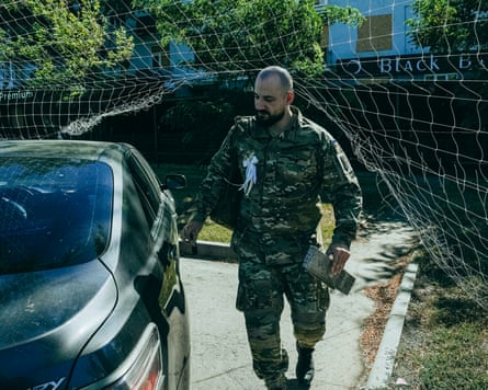 Oleksandr carries loose tiles to hold the rushnyk in place for the ceremony