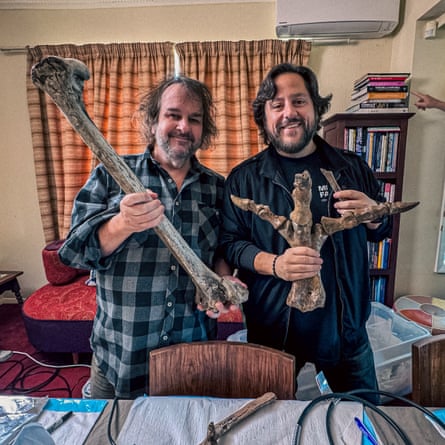 Two bearded men holding fossils