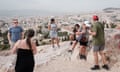 Tourists at a viewing site beneath the Acropolis in Athens, Greece