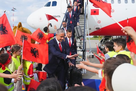 Sylvinho leads his Albania team off the plane as they arrive in Dusseldorf for Euro 2024.