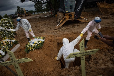 Workers bury a person who died with Covid in Manaus, Amazonas, Brazil, on 27 January.