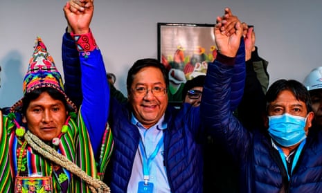 Luis Arce, centre, celebrates with his running mate David Choquehuanca, right